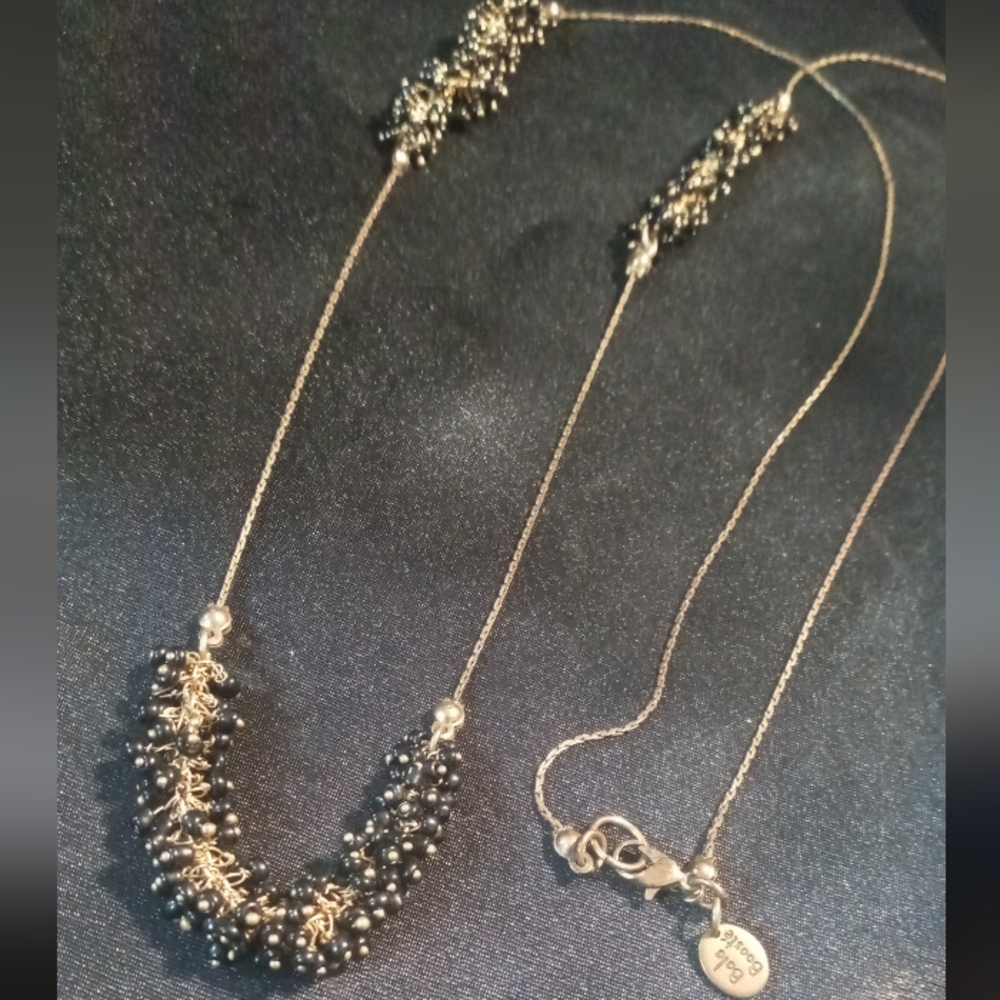 Elegant Gold Necklace with Long Chain and Textured Dangling Elements